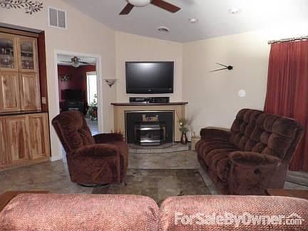 Fireplace view of great room : Fireplace is built around pellet stove insert with raised hearth.