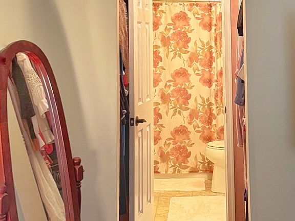 Pass through walk in closet to the full primary bathroom