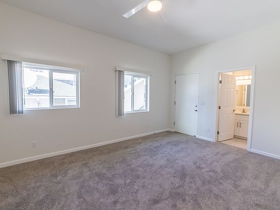 LARGE bonus room with bathroom and 2 bright windows, ceiling fan and small outdoor area.