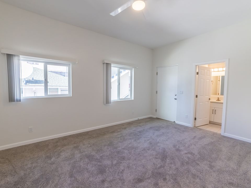 LARGE bonus room with bathroom and 2 bright windows, ceiling fan and small outdoor area.