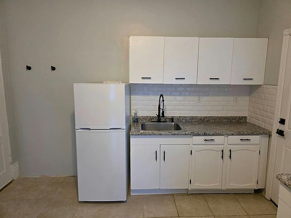 New backsplash and sink - freshly painted cabinets with new black handles