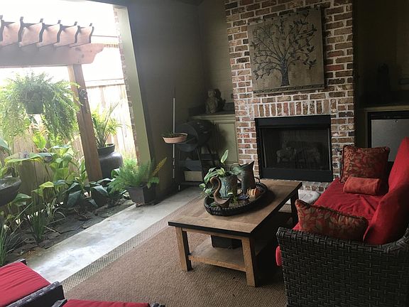 Patio with Fireplace, Fountain, Pergola, and Tropical Flora