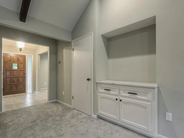 A marble countertop on the built in cabinet / bar area reflects the tone of calm elegance.