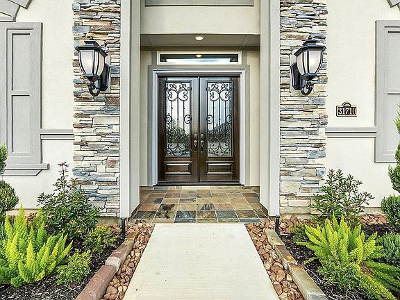 Double door entry with stacked stone.