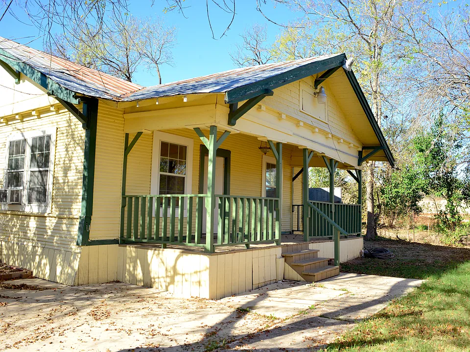 This is the main entrance (front entrance) of the house, which also has a porch surrounded by grass and green area.