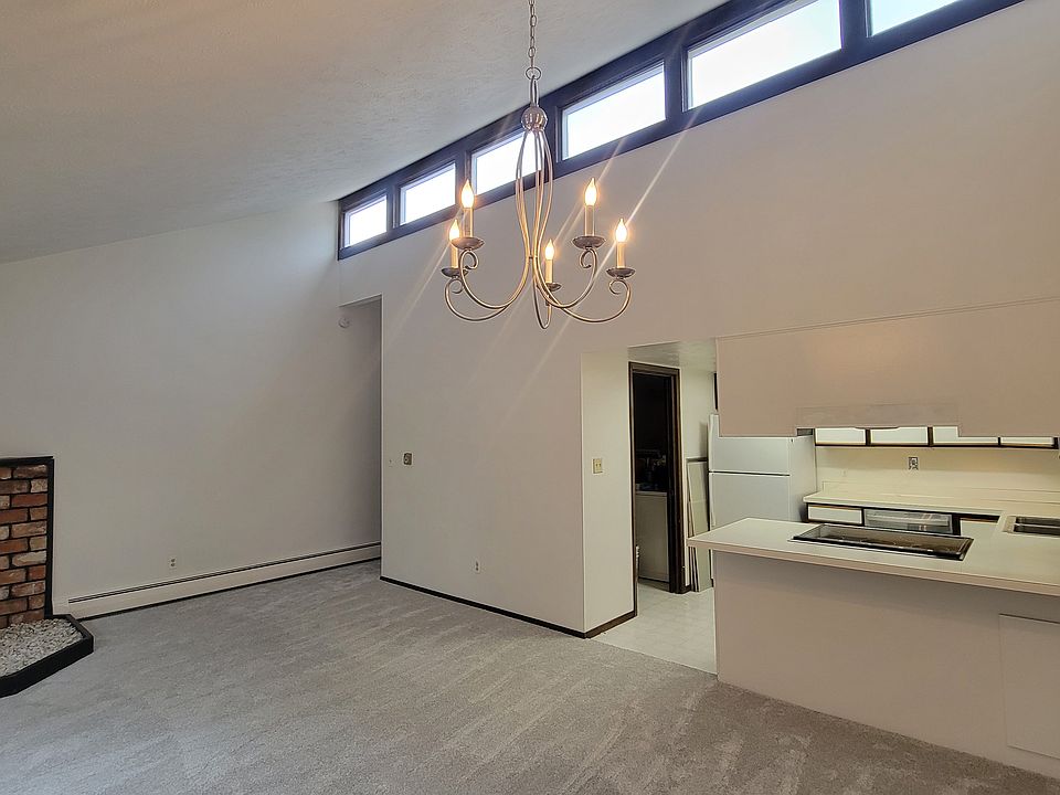 Living room with fireplace, vaulted ceilings and plenty of light!