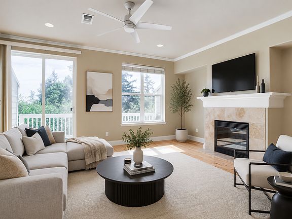 Family Room with gas fireplace, deck and wood floors.