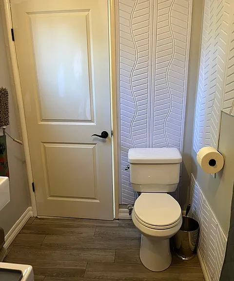 Inside laundry room with 2nd toilet and sink.