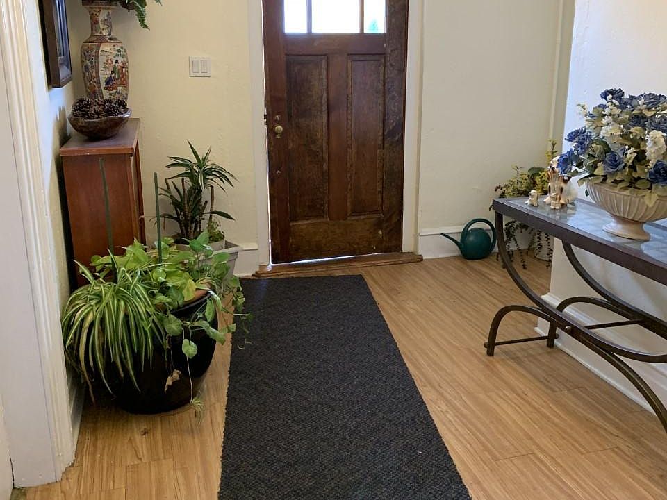 Entry to the house is welcoming, with plants and flowers