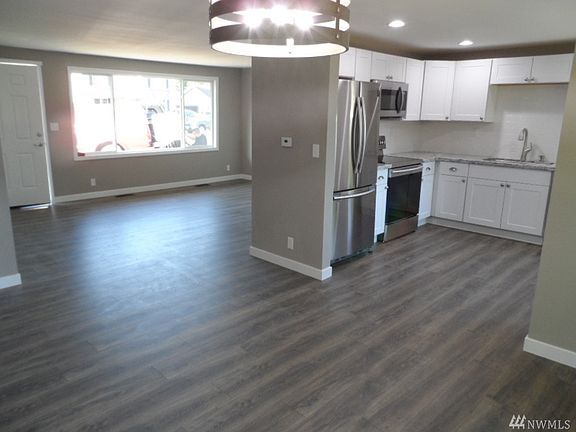 Open kitchen with all new stainless steel appliances, granite countertops and cabinets.