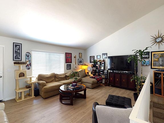 Spacious open living room with hardwood style floors