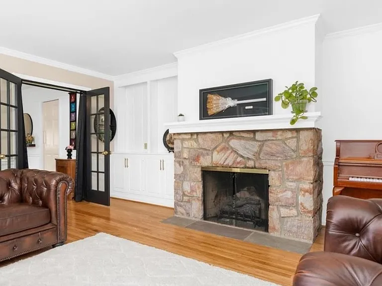 Formal Living room w/gas fireplace. French doors lead to formal dining area...or you can make it into whatever you want...office/guest suite...