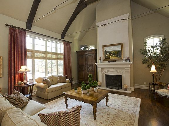 Formal living with beautiful moldings and vaulted and beamed ceiling.