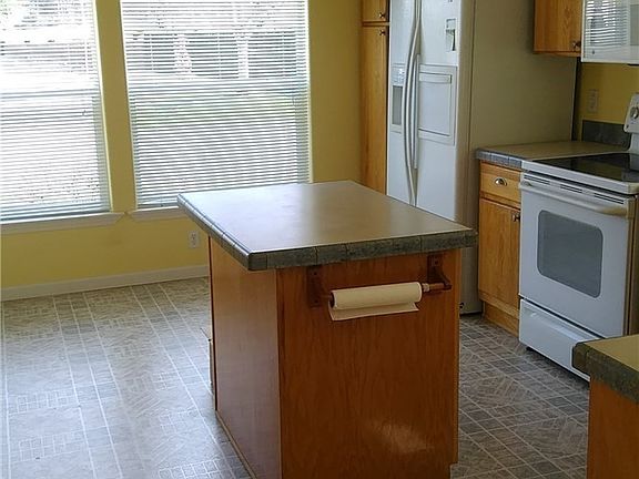 Large den w/double doors and picture window. Large enough to accommodate all your technology equipment