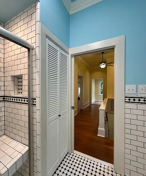 A pocket door with translucent round window provides privacy here.