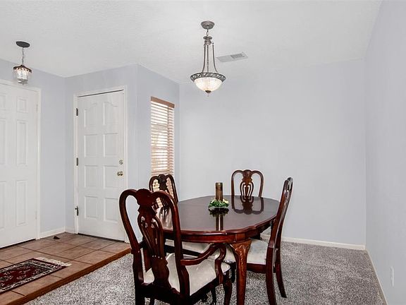 Spacious dining area with new carpet and fresh paint