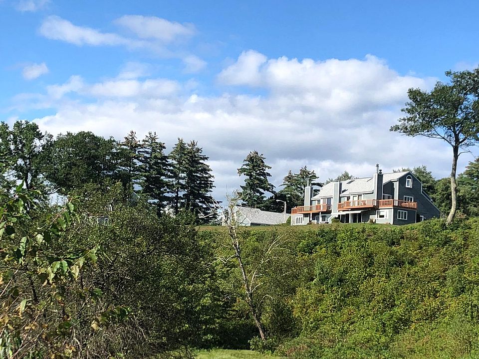 view of unit from lower field. Field and walking trails on association property