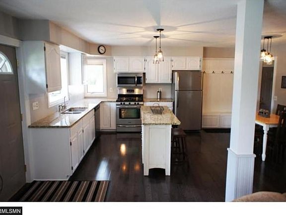 The floors are updated hardwood and back door area has a built in bench and coat hooks next to it.