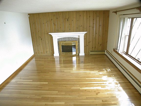 living room with fireplace and gleaming floors