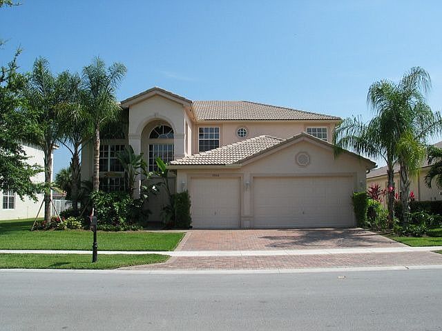 Front of home, which is centered on lake with pool facing south