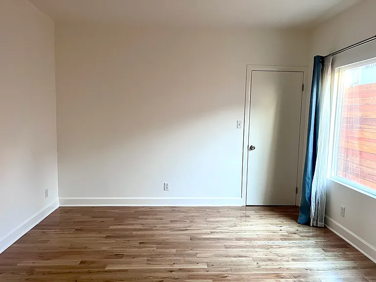 The primary bedroom in the rear of the unit that also includes an ensuite bathroom