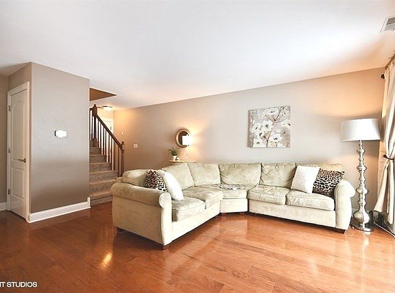 View of Living Room to Foyer, Front Closet & Powder Room