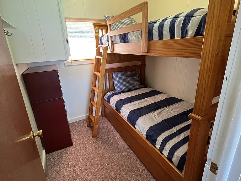 Bedroom 3, bunk beds, hanging cabinet and dresser.