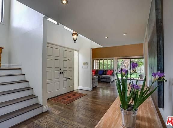 Entry door and hallway leading to living room kitchen and guest bedroom. Stairwell leading to second floor with Master Bedroom and 2 en suite bedrooms.