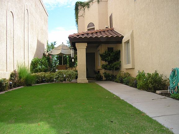 front courtyard with lawn which is enclosed and gated