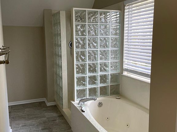 Master bath with shower and jacuzzi tub. Toilet has it's own water closet.