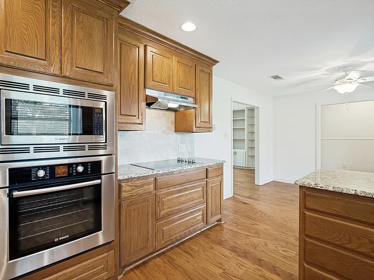 Large spacious kitchen with granite counters.
