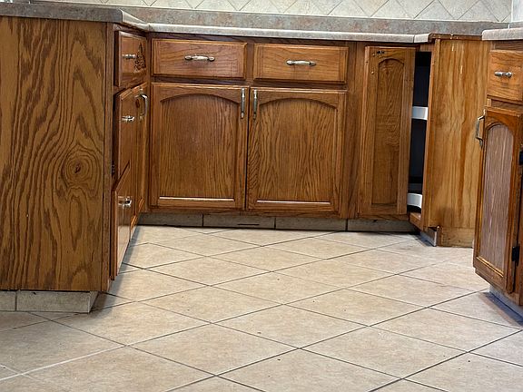 Spacious kitchen facing the patio and fruit trees.