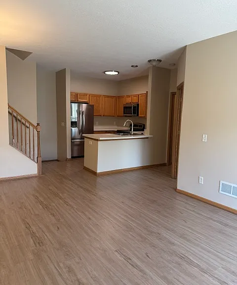 LVP THROUGHOUT MAIN LIVING AREA INCLUDING KITCHEN, DINING, LIVING ROOM AND DEN.
