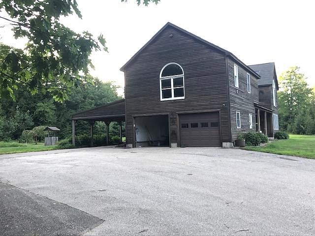 side view showing attached 2 car garage and carport