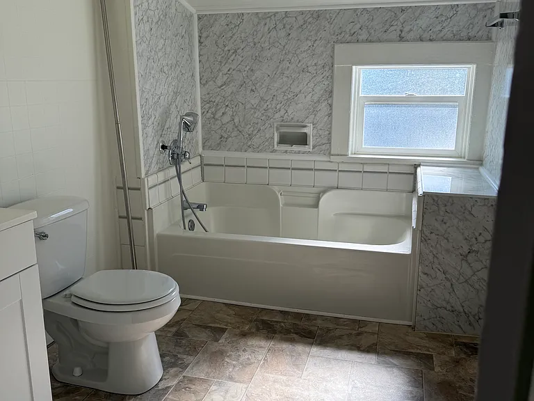 Bathroom view showing tub with sprayer.