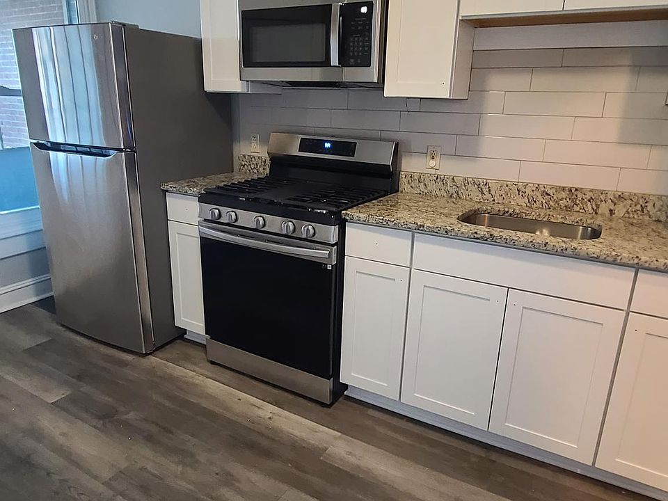 New kitchen cabinets with granite counter and stainless steel appliances