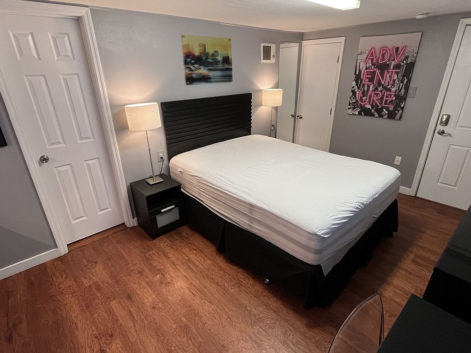 Queen bed, dual night stands with lamps, dresser, desk and chair, 65in Smart TV, full kitchen, bath.