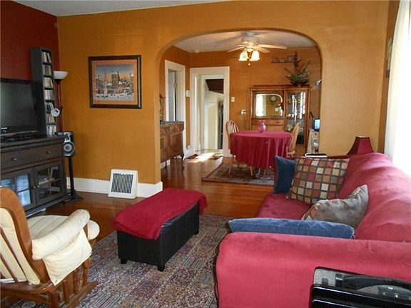 Living room with coved archway to the formal dining room.