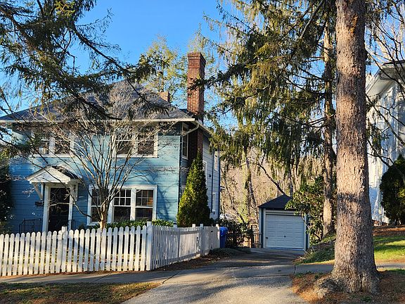 House, driveway, garage and neighbor's attractive home.