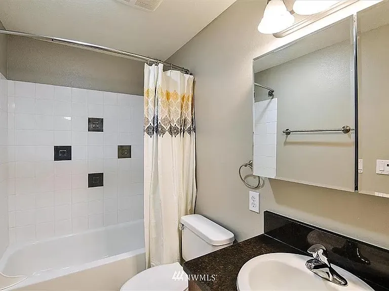 Clean and spacious main bathroom upstairs with tons of storage space, including a closet with sliding drawers.