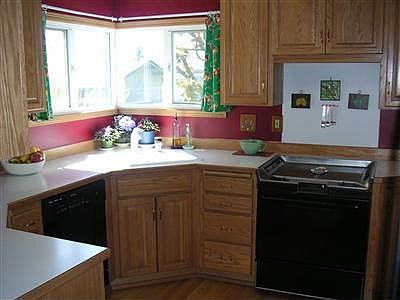 The kitchen faces south and west, has hardwood floors and has custom cabinets.