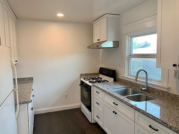 Newly renovated kitchen: New cabinets, countertops, sink, faucet, and a fully ducted stove hood.