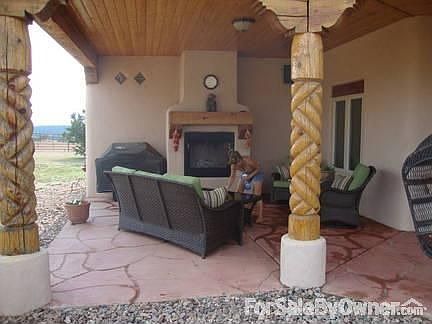 Fire Place on back porch, displaying Vigas