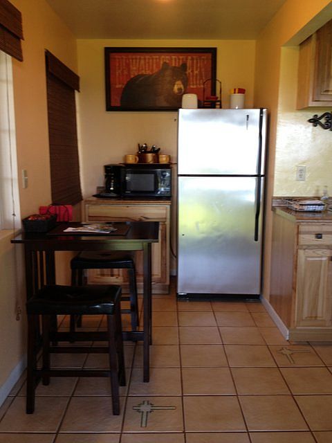 range, refrigerator, micro wave, toaster, sink, kitchen table spectular
view, some basic, pot, pans silverware. dishes