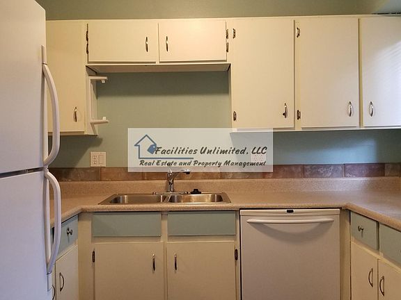 Kitchen with refrigerator, dishwasher, and electric range