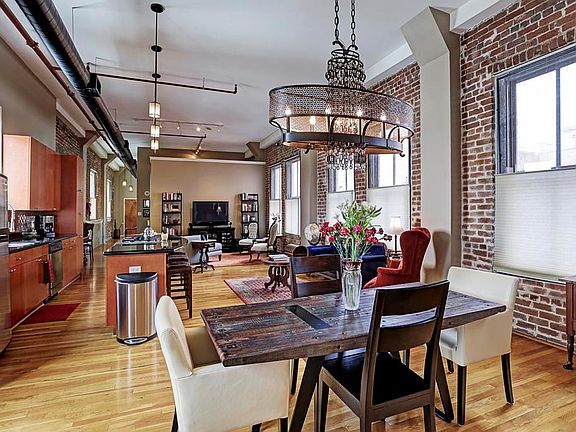Another view of the open living, kitchen & dining areas. Because this unit has no common walls with the rest of the building, it allows for windows on both sides, flooding the space with natural light.