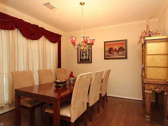 Formal dining has beautiful wood flooring. 