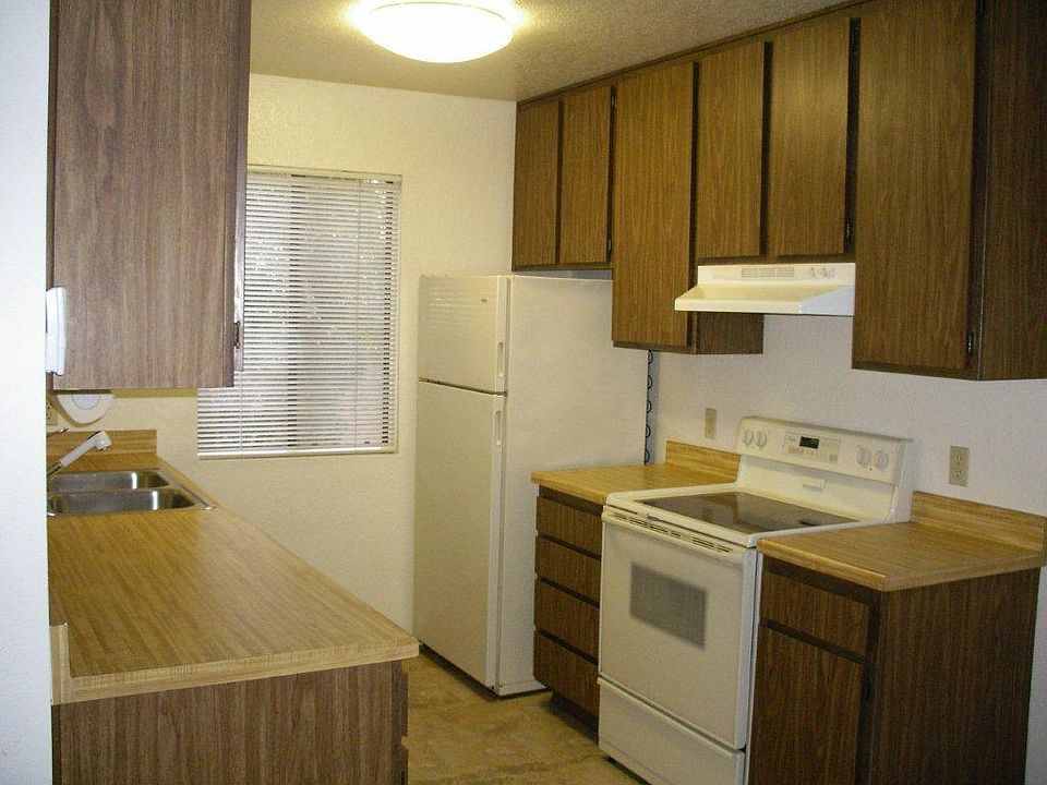 Kitchen with glass top stove, refrigerator and dishwasher.