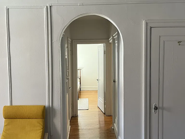 Hallway leading to bathroom, bedroom and kitchen.