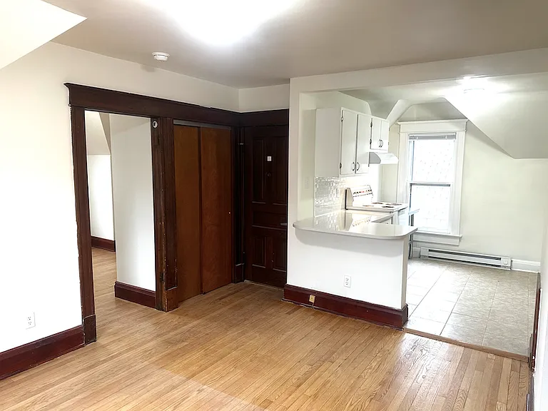 Natural woodwork and hardwood floors throughout.